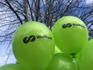 Green balloons depicting the WellFood logo