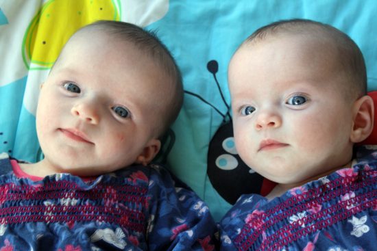 Young twins looking at the camera